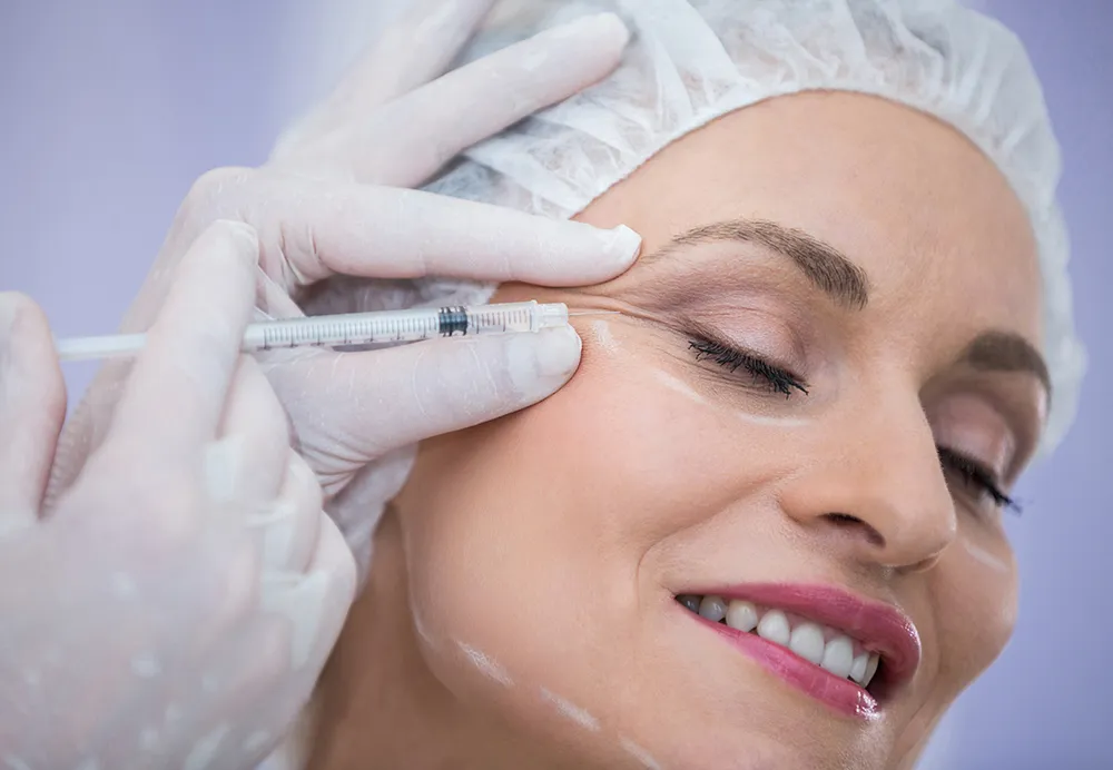 A medical professional performing a PRP facial rejuvenation treatment on a client's face to improve skin texture 1000x692
