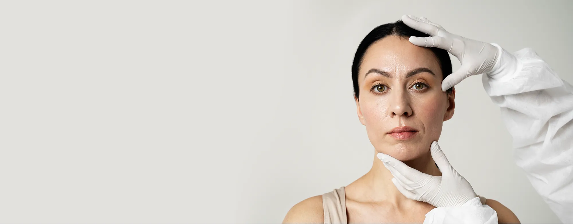 Dermatologist performing non surgical skin tightening treatment on woman's jawline at Dermatrix clinic 2000x785