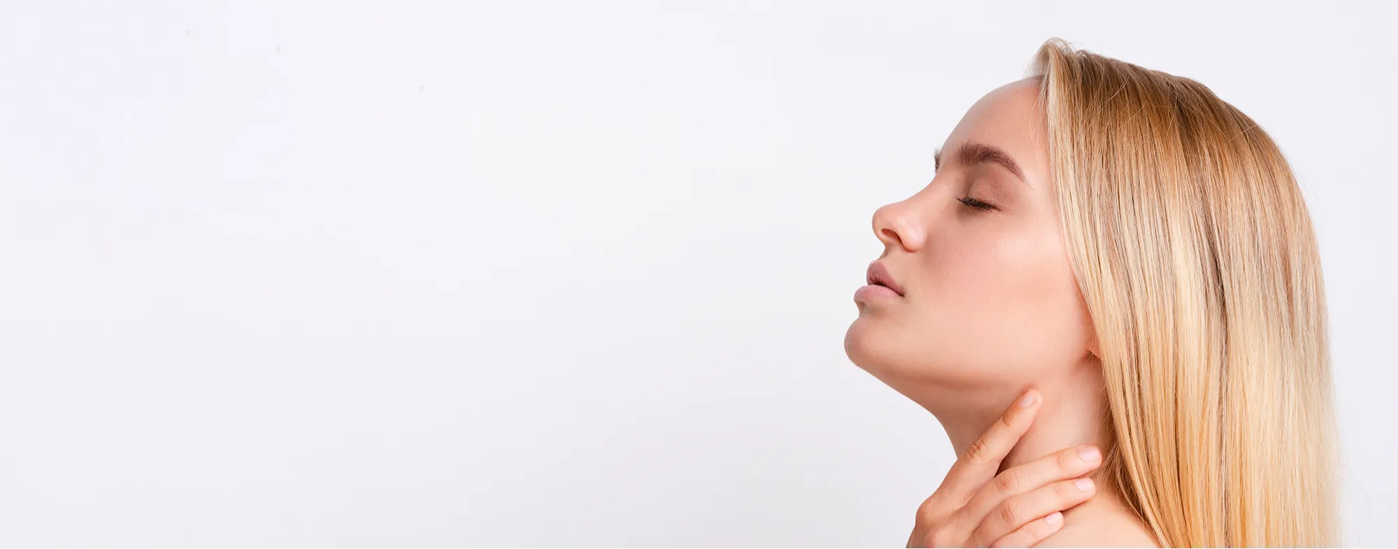 Profile of a woman showing smooth facial contours and lifted jawline after a liquid face lift treatment 2000x785