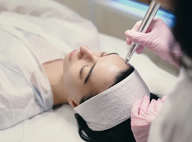 Medical professional performing advanced facial treatment for fine lines and skin rejuvenation 620x460