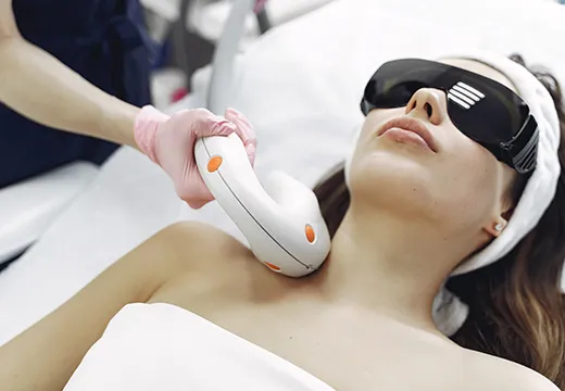 Patient receiving professional laser hair removal treatment on the neck at a dermatology clinic 520x360 (1)