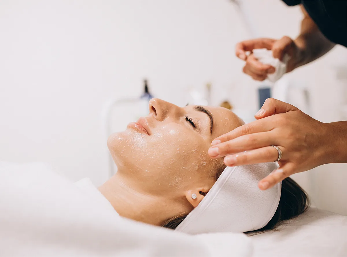 Professional aesthetician performing a red carpet facial treatment on a dermatrix client for glowing skin 1200x890
