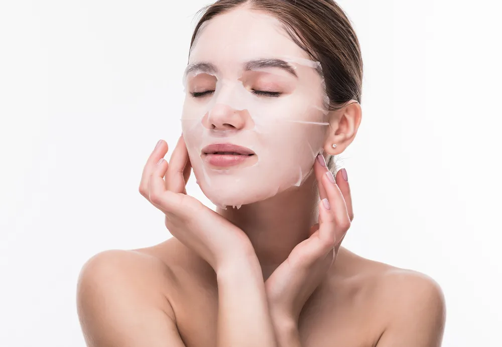 Woman with radiant skin receiving a dermatology designed signature facial treatment 1000x692
